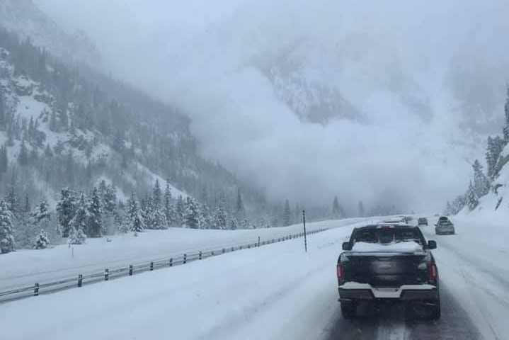 A plume of smoke rises as an avalanche crashes down a mountain in Colorado.