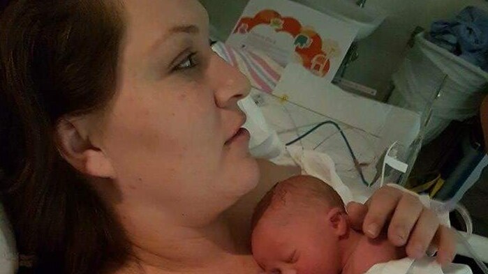 Mum Claire in hospital holding her newborn