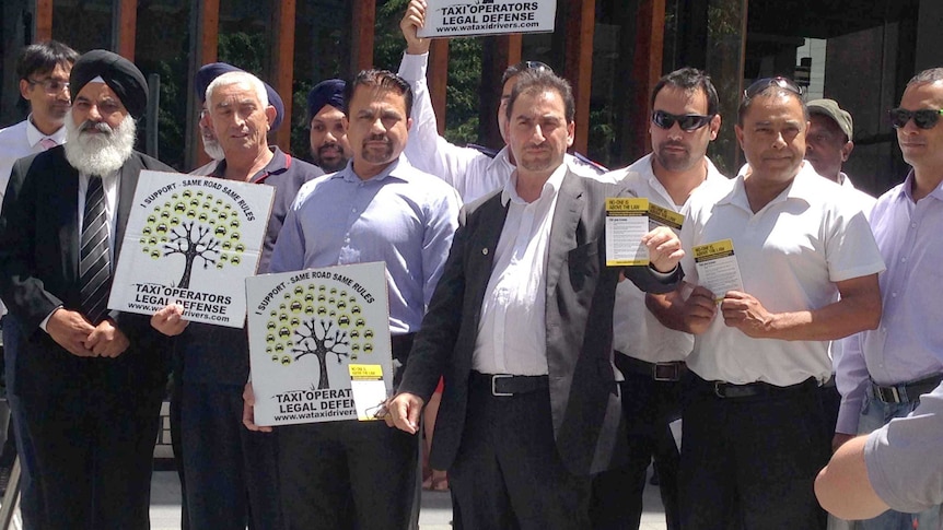 Taxi drivers holding placards outside the WA Supreme Court.