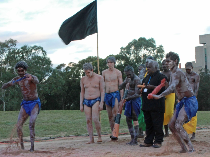 A black flag signifies the solemn purpose of the memorial ceremony.