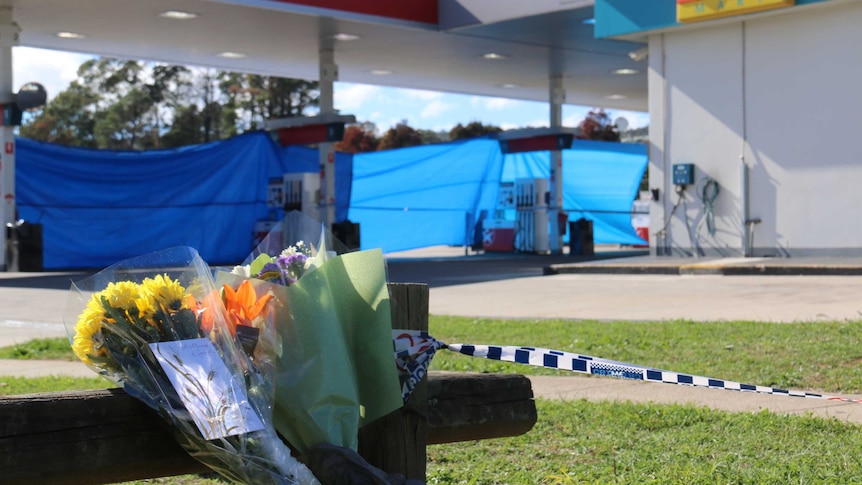 Flowers at the scene of a fatal stabbing at a Caltex service station in Queanbeyan.
