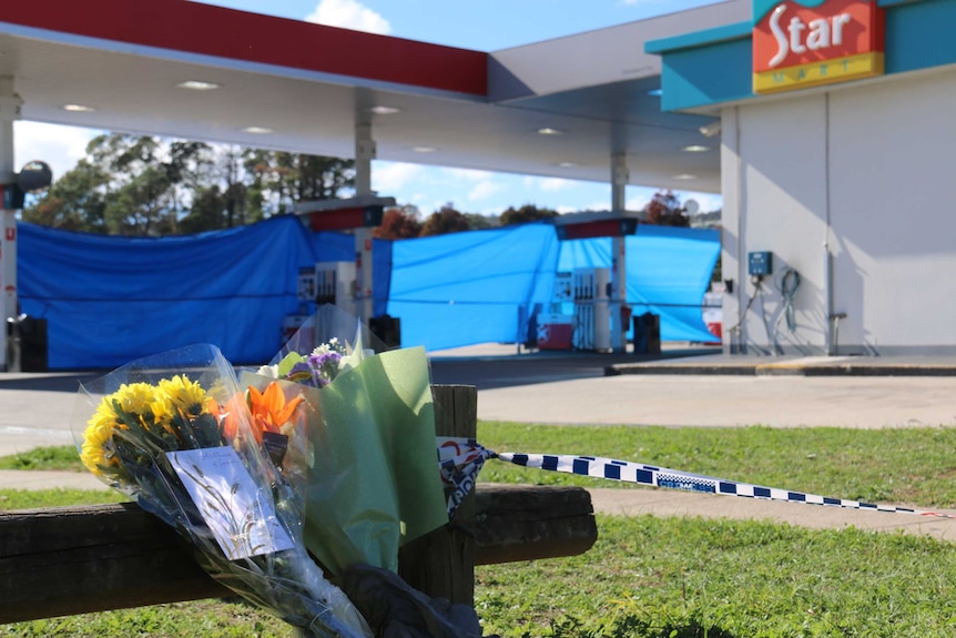 Flowers at the scene of a fatal stabbing at a Caltex service station in Queanbeyan.