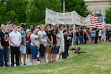People gather for a prayer vigil in Aurora
