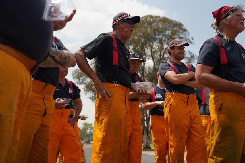 A group of firefighters stand for a briefing near Warwick in Qld.