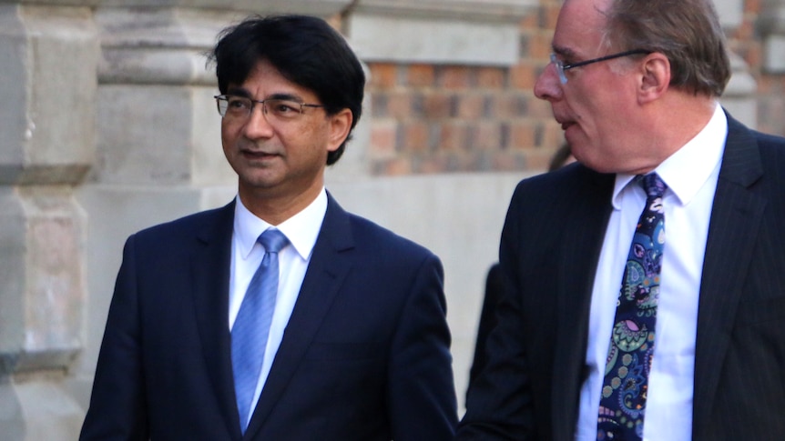 Mid-shot of Lloyd Rayney with Martin Bennett outside a court building.