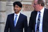 Mid-shot of Lloyd Rayney with Martin Bennett outside a court building.