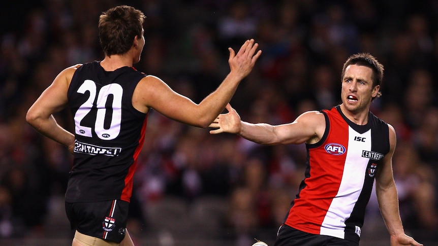 Saints forward Stephen Milne celebrates a goal with team-mate David Armitage against Fremantle