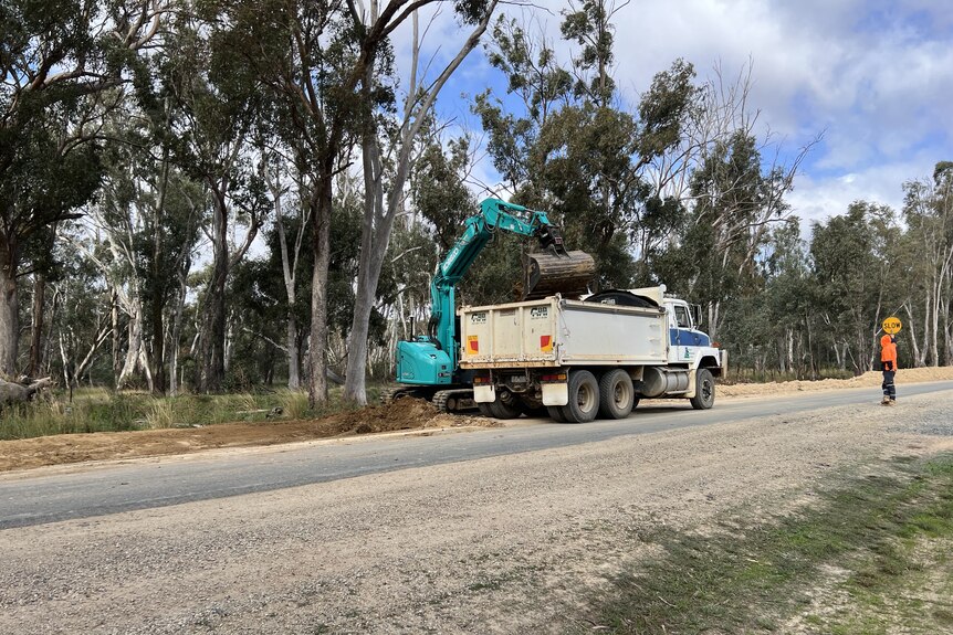 A crane lifts sod onto a truck in northern Victoria.