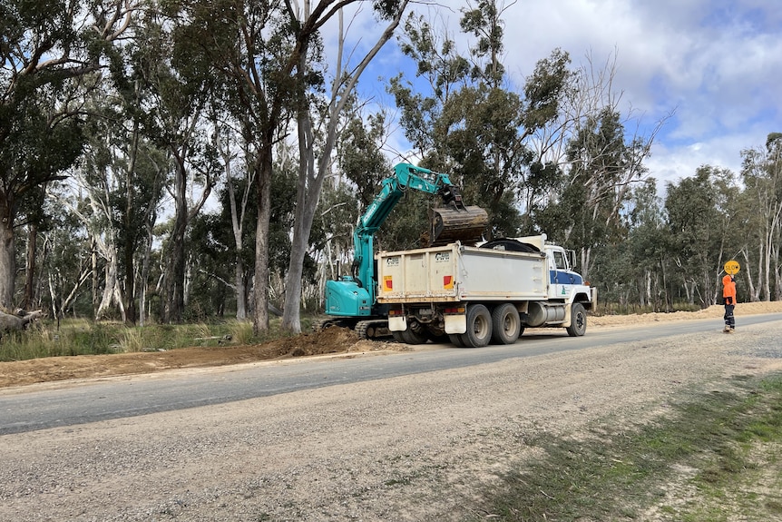 A crane lifts sod onto a truck in northern Victoria.