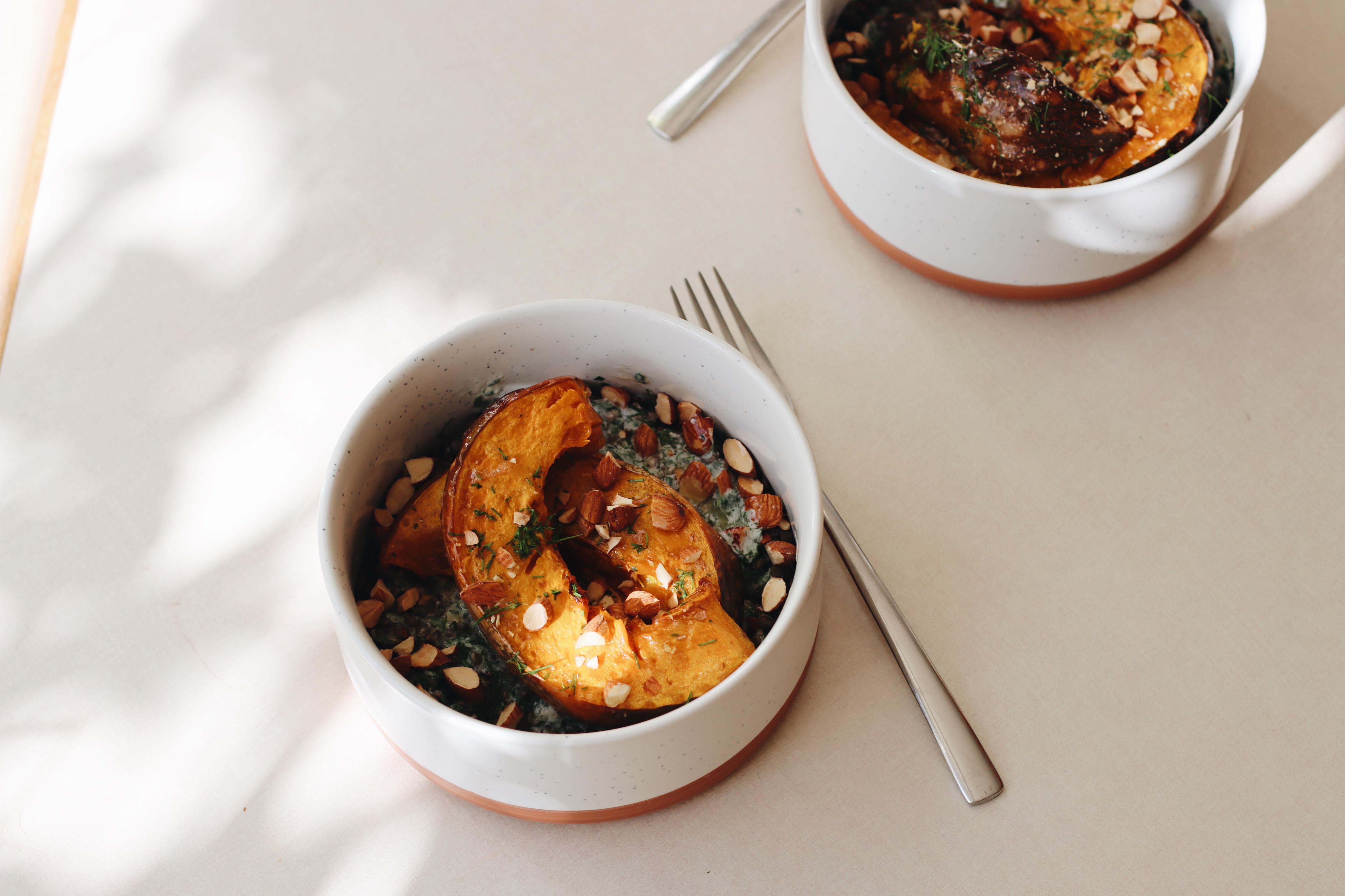 Bird's eye view of pumpkin and lentils served in a bowl with a spoon.