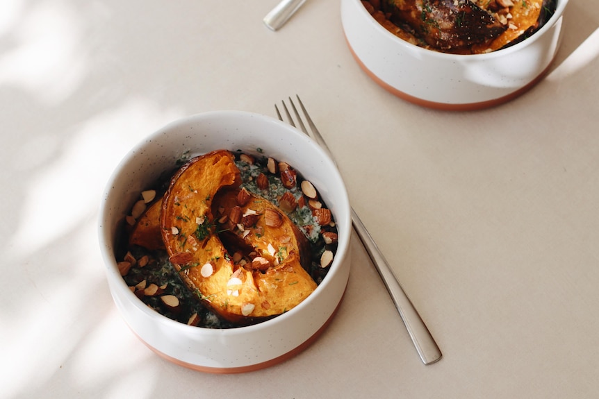 Bird's eye view of pumpkin and lentils served in a bowl with a spoon.