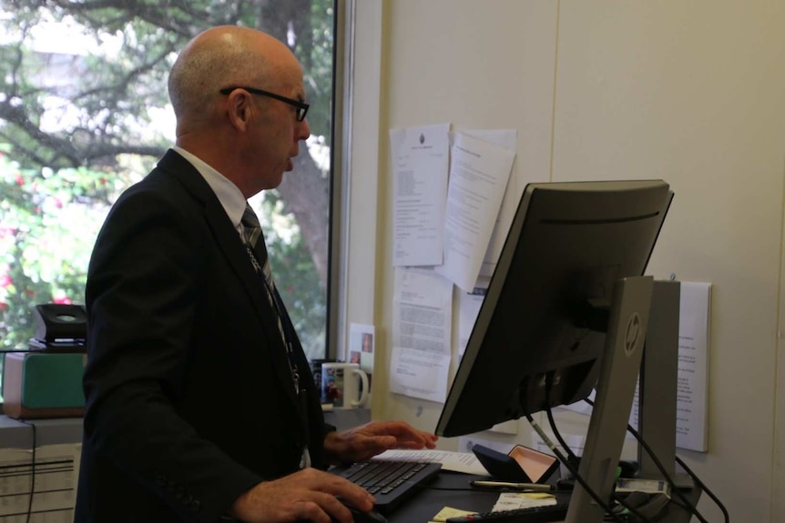 Detective Inspector Kim Steven, who is in charge of the Victoria Cafasso murder investigation, stands at a computer.