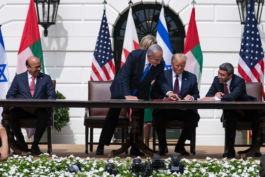 Donald Trump overseas leaders of Israel, Bahrain and UAE signing an agreement in front of the White House.
