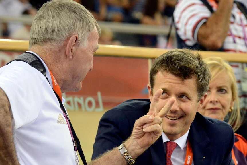 Swimming coach Laurie Lawrence speaks with Denmark's Crown Prince Frederik at the London velodrome.