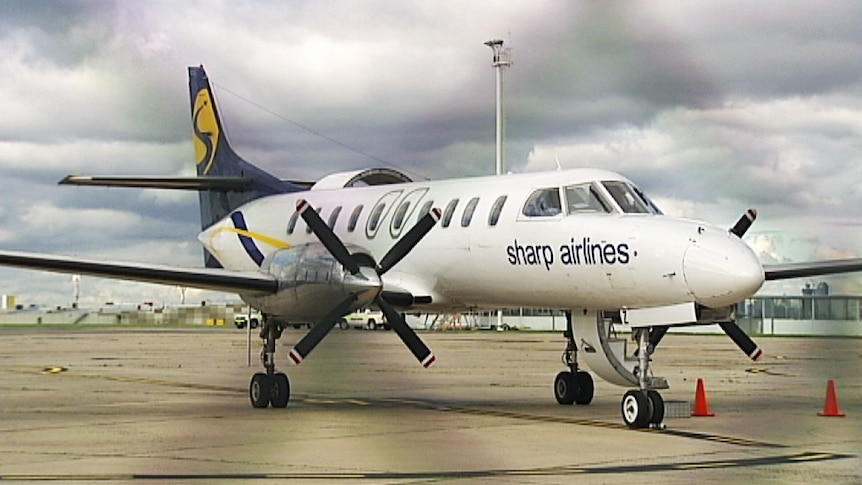 A Sharp Airlines plane sits on the tarmac at Essendon Airport after making an emergency landing.