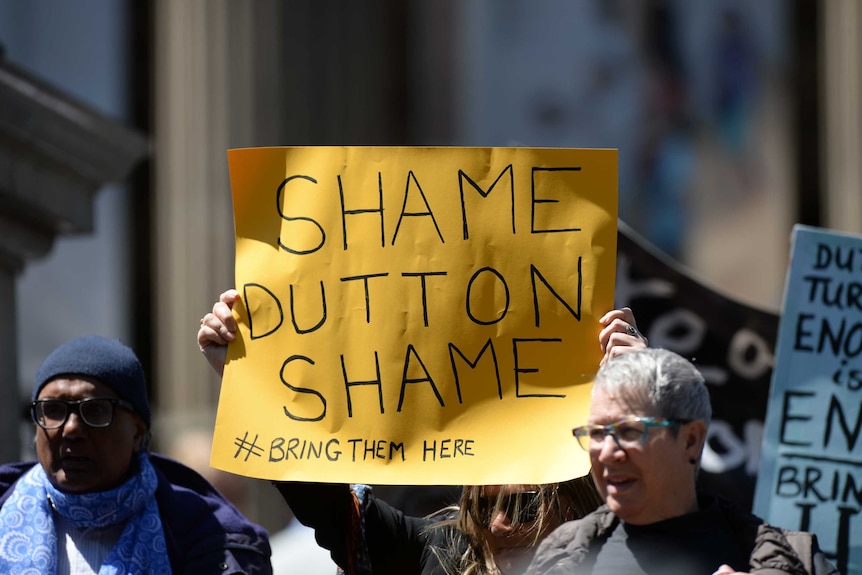 Protesters rally outside the State Library of Victoria against the treatment of refugees stuck on Manus Island.