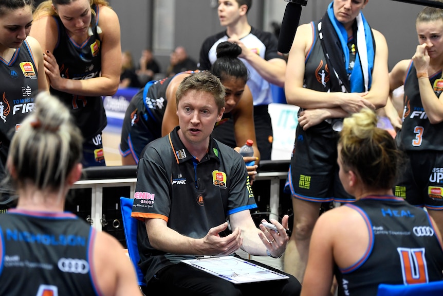 WNBL coach talking to his team at quarter time