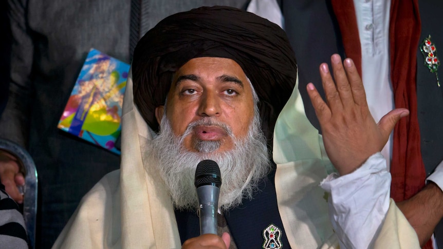 head of the Pakistani Tehreek-e-Labbaik party chief Khadim Hussain Rizvi speaks into a microphone at a press conference