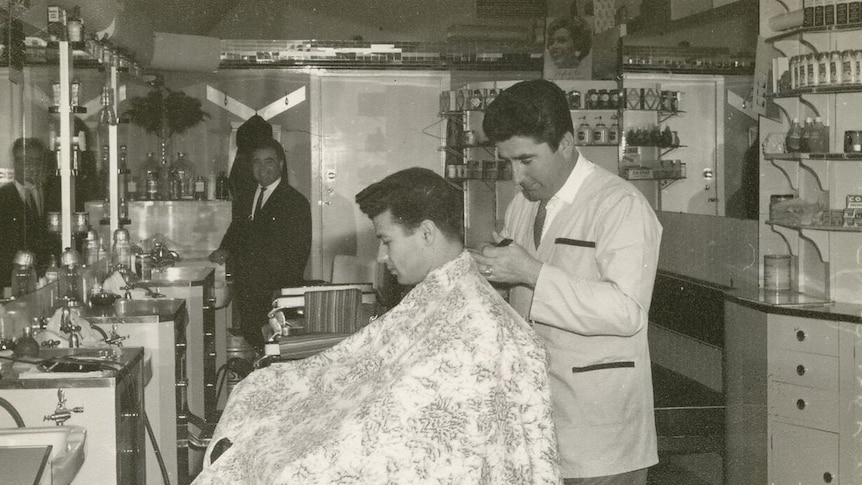 Giuseppe Cataldo cutting hair in his Canberra salon in the 1960s.