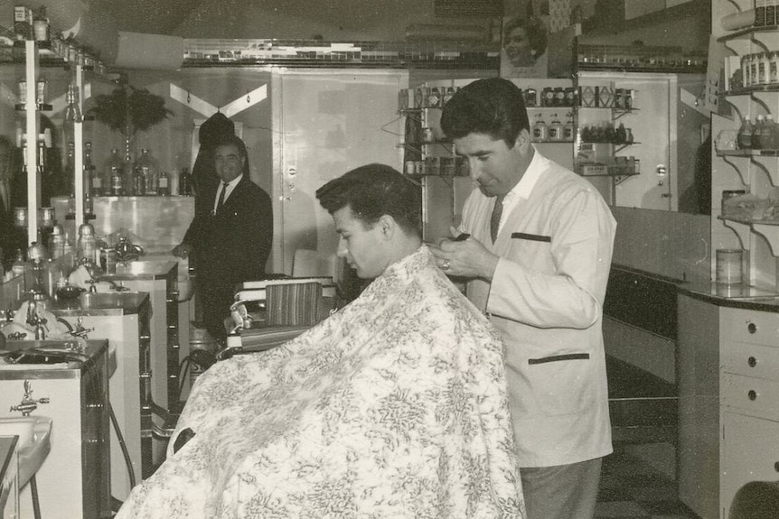Giuseppe Cataldo cutting hair in his Canberra salon in the 1960s.