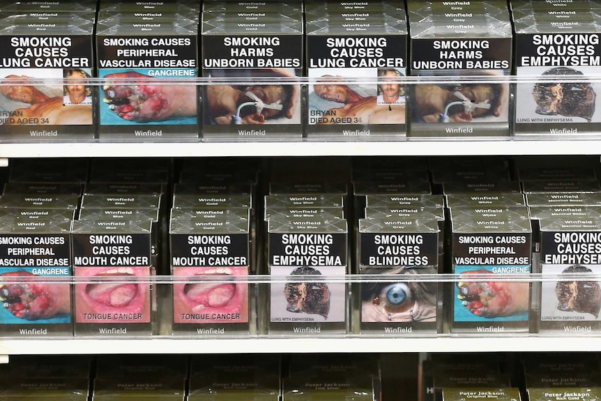 Cigarette packets with health warnings are displayed in a convenience store in Sydney.