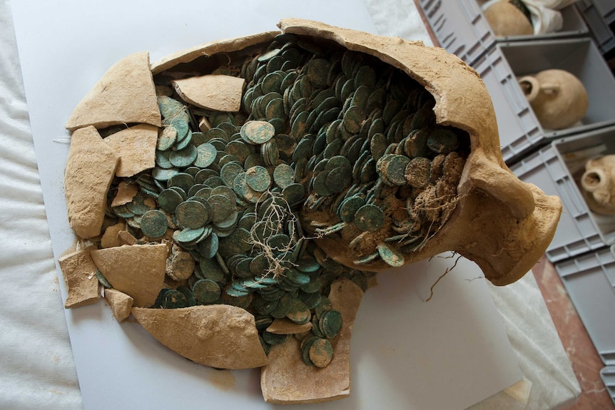 A Roman amphora filled with bronze coins.