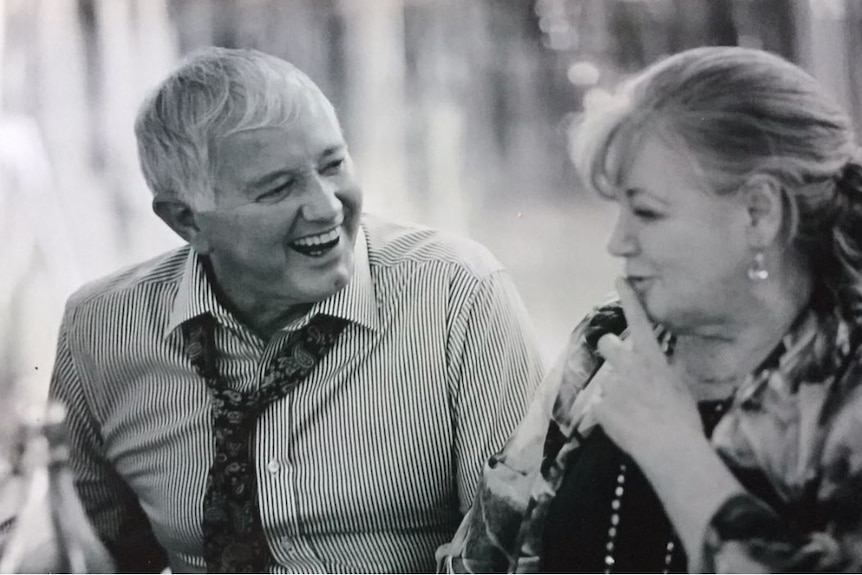 Phot of a older man and woman laughing together.