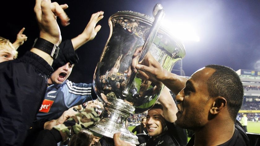 Battle royale... Joe Rokocoko holds the Bledisloe Cup up to the New Zealand crowd in 2007 (file photo).