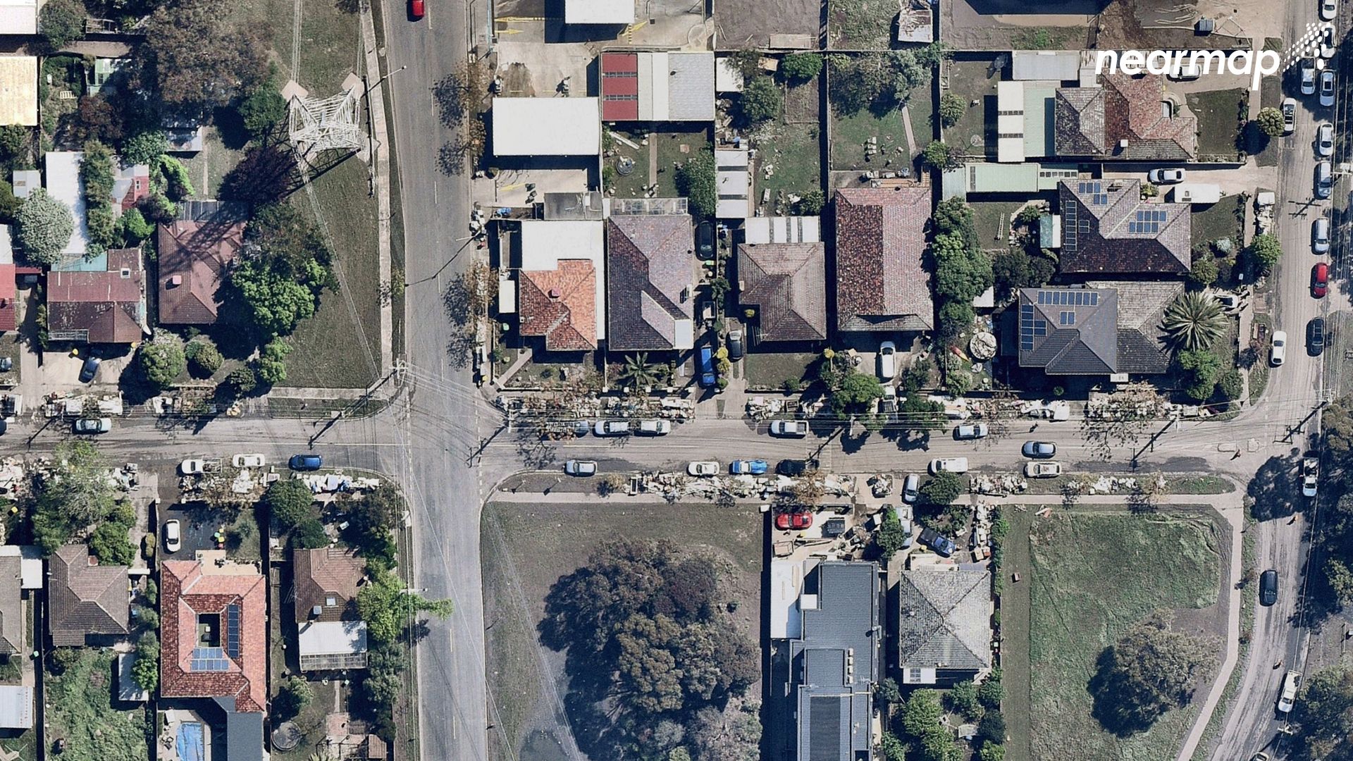 Mud can be seen over the roads, while homes have rubbish left out the front, from flood damage