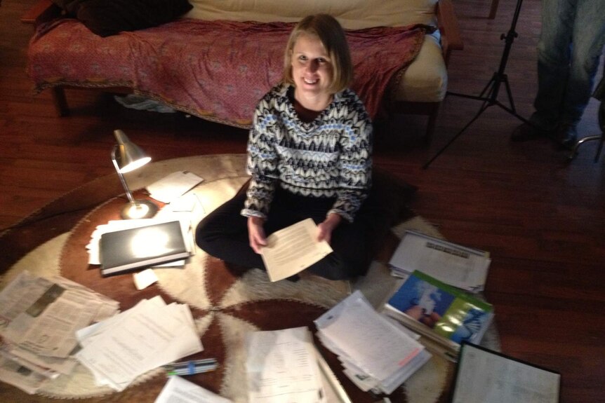 Lauren Burns with paperwork in the search for her biological father.