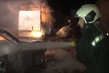 Men battle a fire after a hospital bombing