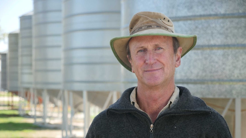 CBH Group director, Trevor Badger stands in front of grain silos on his Pingrup farm.