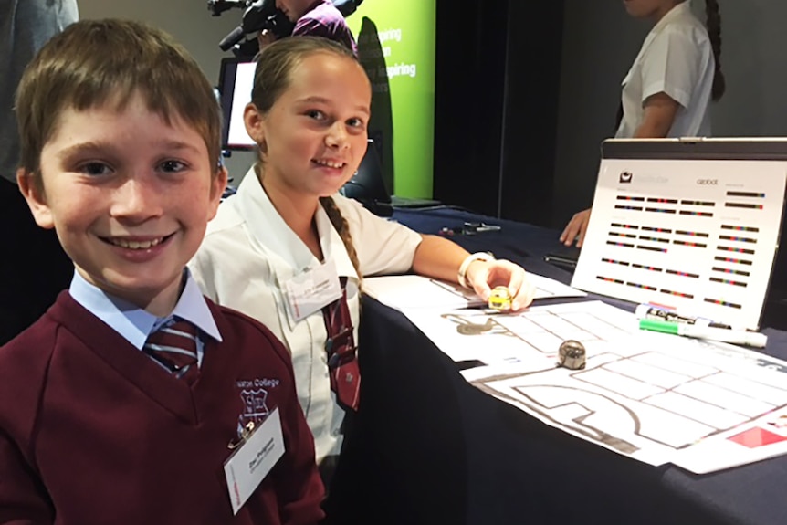 Ormiston Year Six students Zac Polgase and Ally Bannister programming mini robots.