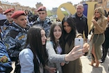 Kim Kardashian poses for a picture with local residents Yerevan