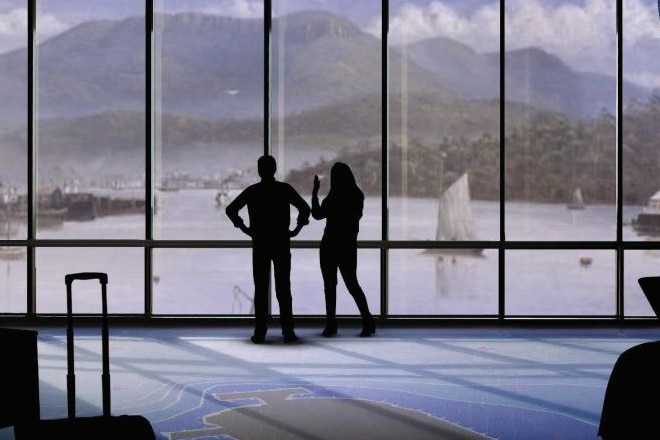 A graphic image of a couple standing in a window with a view of a mountain