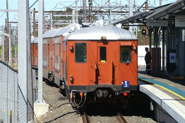 A red rattler coupled with a double-decker Tulloch carriage