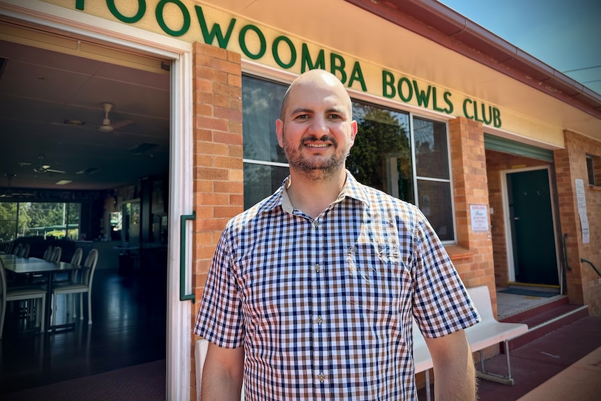 A man stands in front of the Toowoomba Bowls Club building