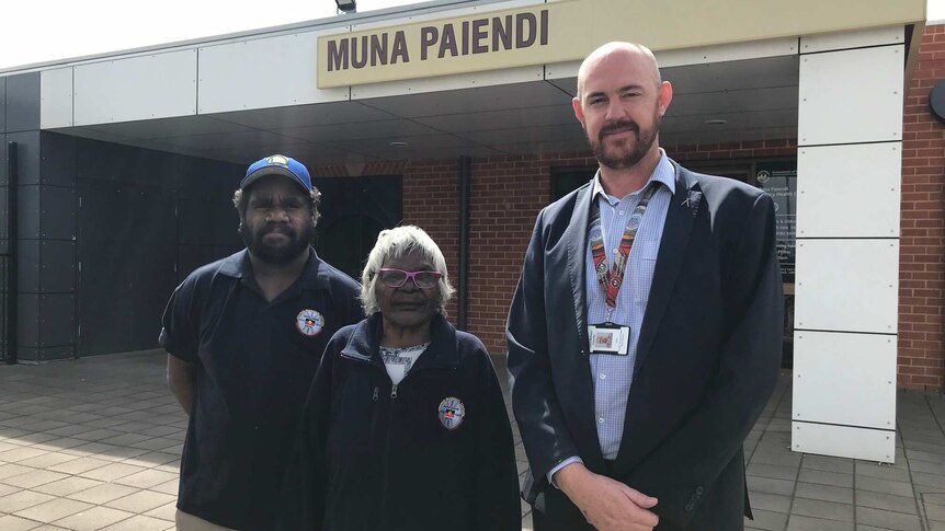 Two Aboriginal healers stand beside executive director of Aboriginal health services, Kurt Towers