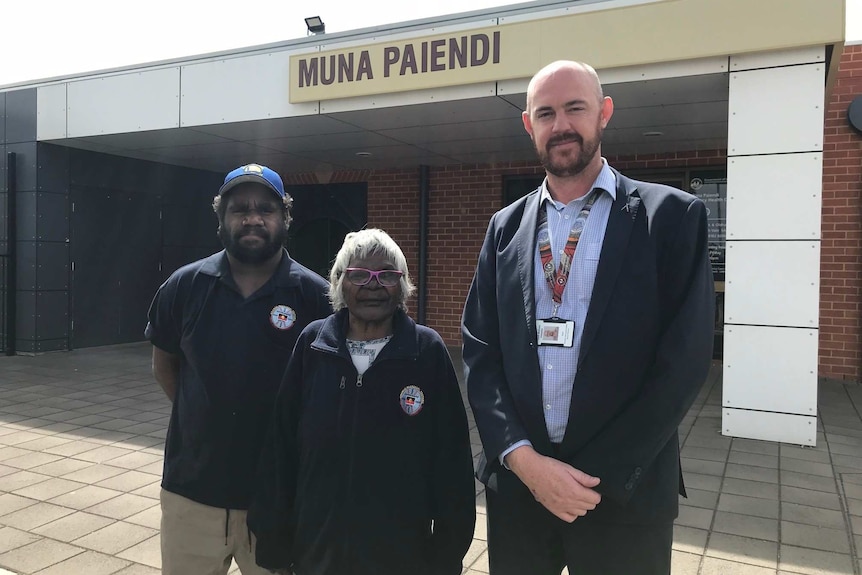 Two Aboriginal healers stand beside executive director of Aboriginal health services, Kurt Towers