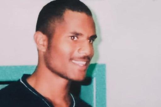 A young Torres Strait Islander man with short hair and black t-shirt.