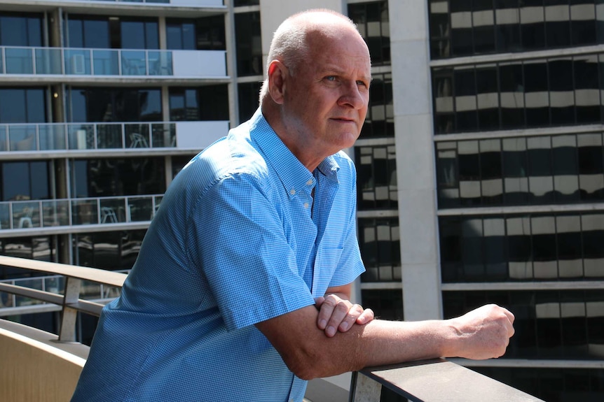 Chris Clark on his apartment balcony at Docklands in Melbourne