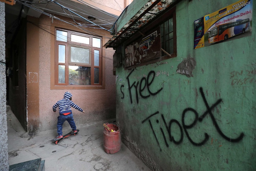 A boy rides a skateboard at the Tibetan Refugee Colony in New Delhi