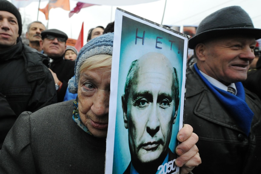 Protester holds Putin poster