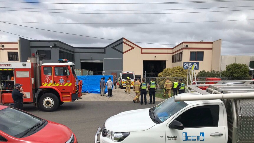 Police and firefighters outside a business.