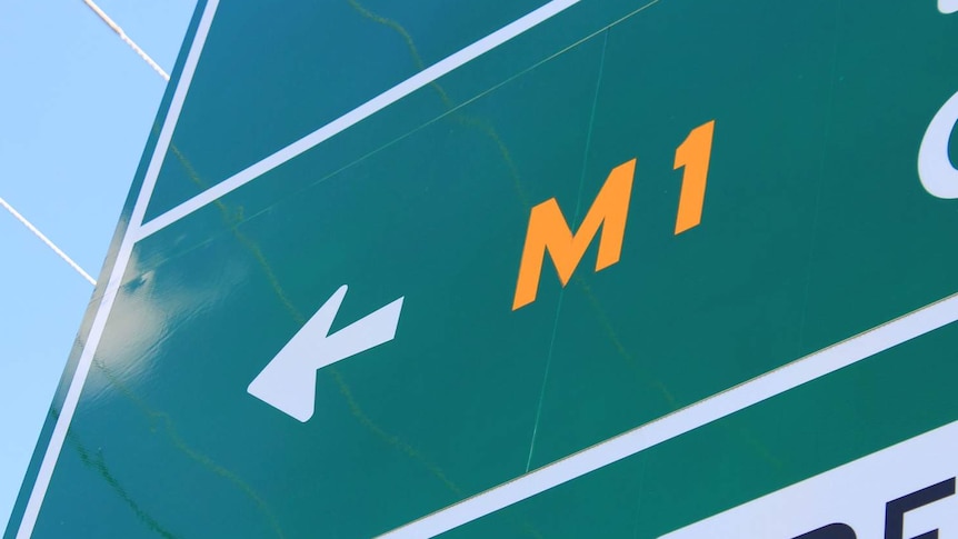 Road sign pointing to a ramp to the M1