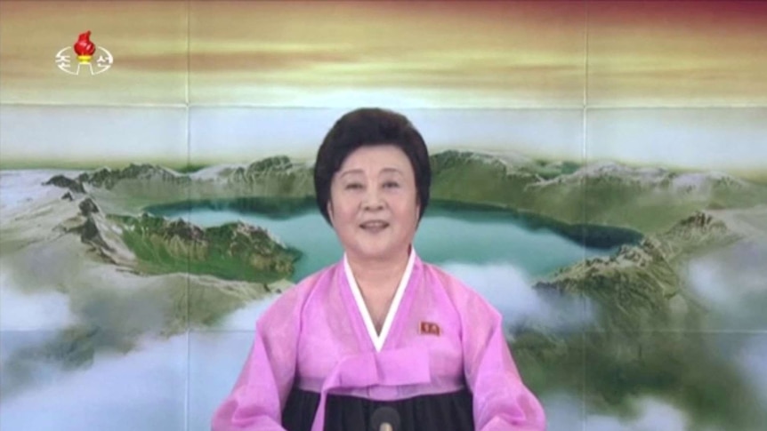 A female TV announcer addresses the camera.
