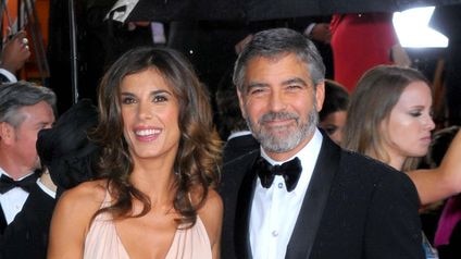 Actor George Clooney, right, and Elisabetta Canalis arrive at the Golden Globes