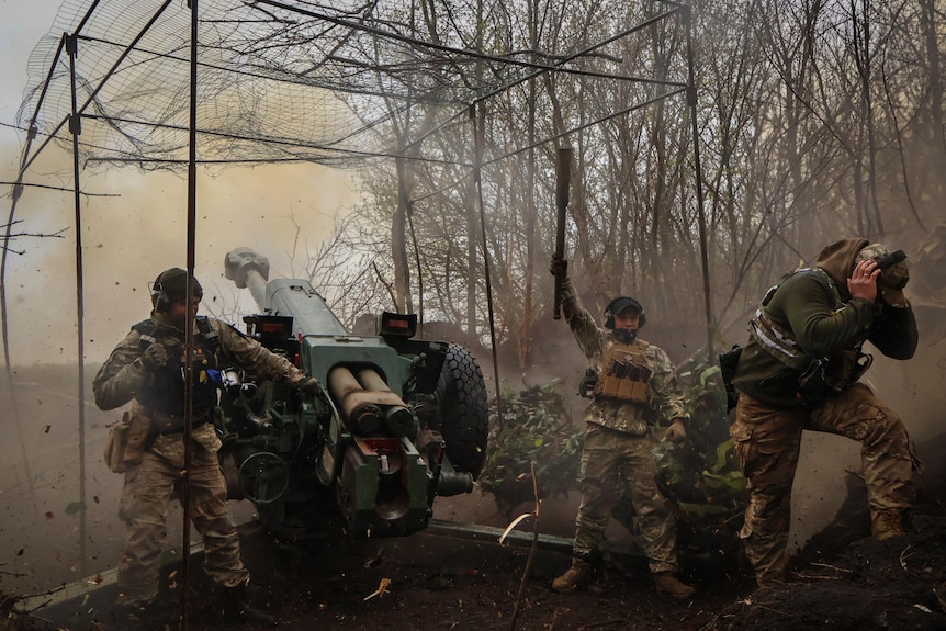 Ukrainian soldiers fire howitzer D-30 at the frontline near Bakhmut.