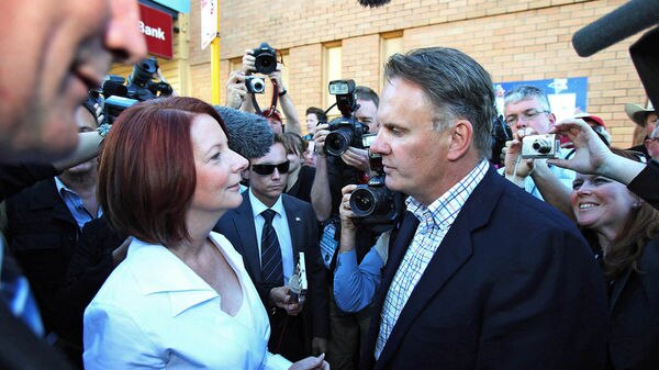 Press pack surrounds Prime Minister Julia Gillard as she is confronted by Mark Latham (Gary Ramage, AAP)