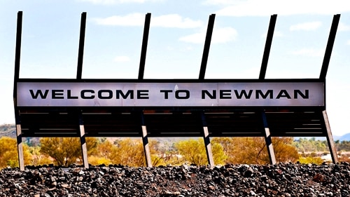 A 'Welcome to Newman' sign on mining equipment installed on the edge of town.
